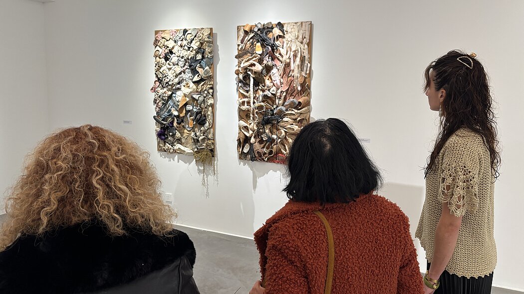 trois femmes regardent un tableau