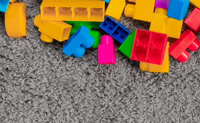 briques de légo colorées sur tapis gris 
